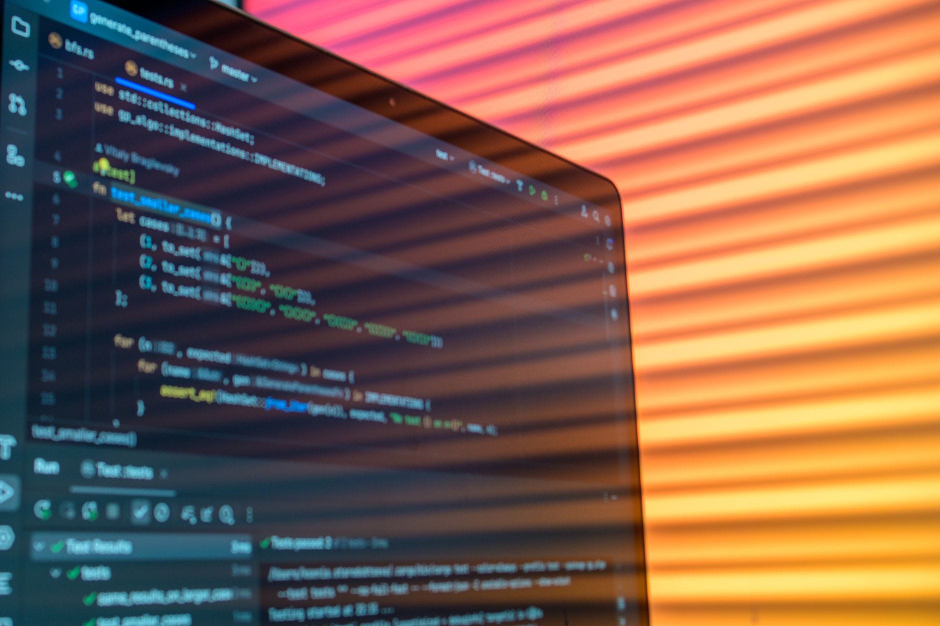 Close-up of computer code on a screen illuminated by warm lighting patterns, creating an artistic tech vibe.