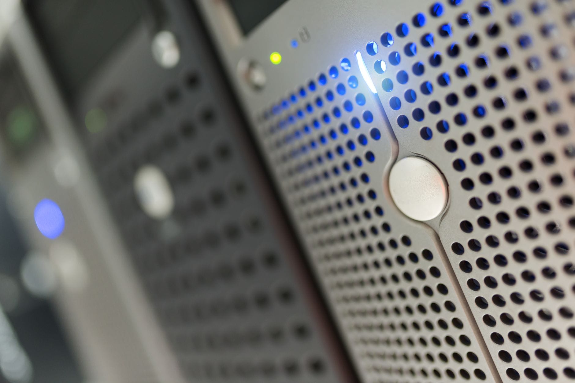 Server room with blue lights glowing in rows of racks, evoking a data center atmosphere.
