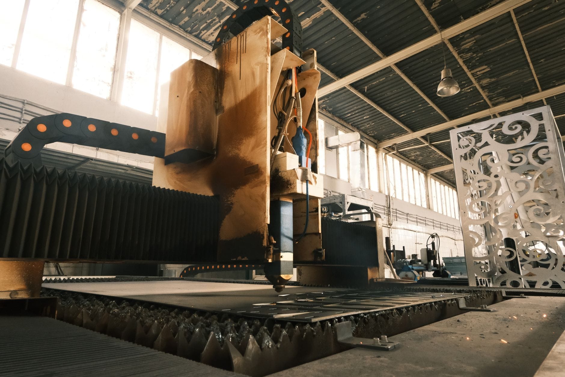 Close-up of a laser cutter in an industrial factory, showcasing modern manufacturing technology.